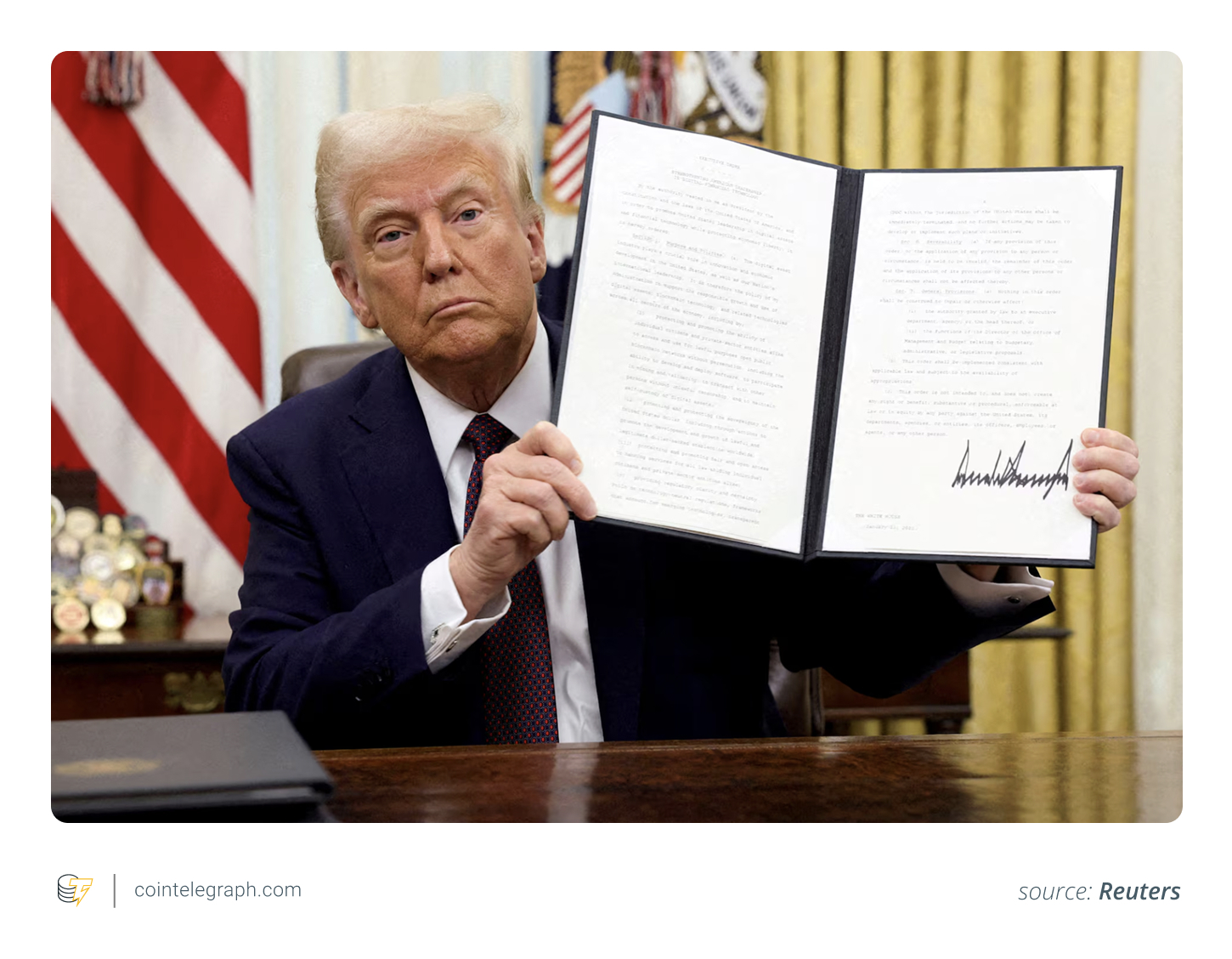 US President Donald Trump holding a signed executive order on cryptocurrencies, in the  White House, January 23, 2025
